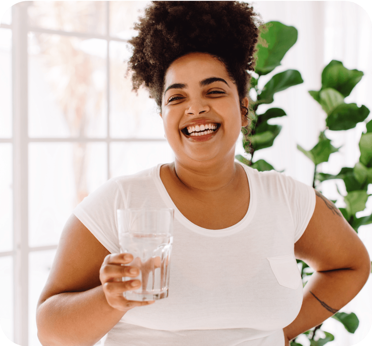 Woman smiling and holding a glass of water